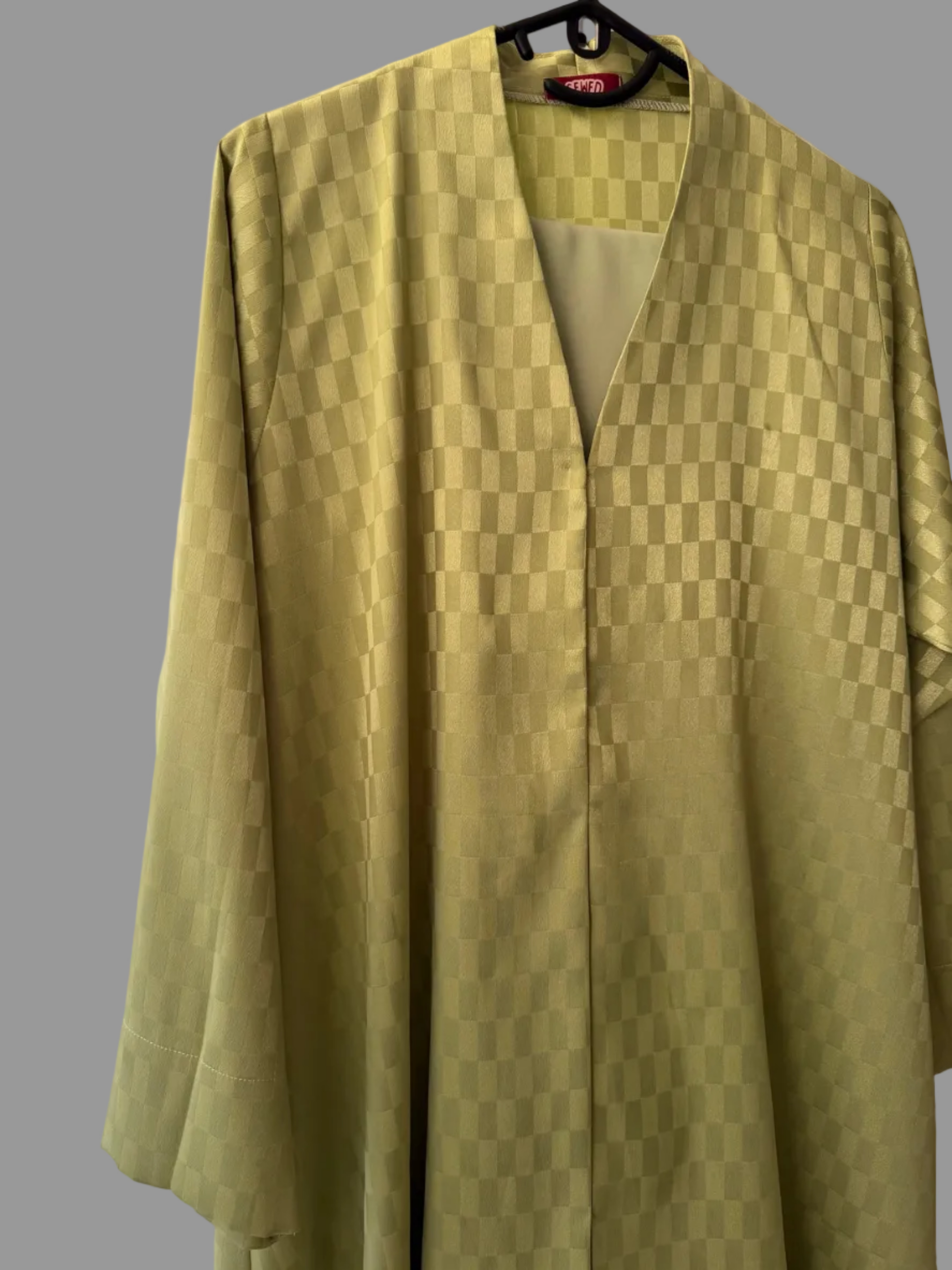 A light olive green kimono-style cardigan with a subtle checkerboard pattern.